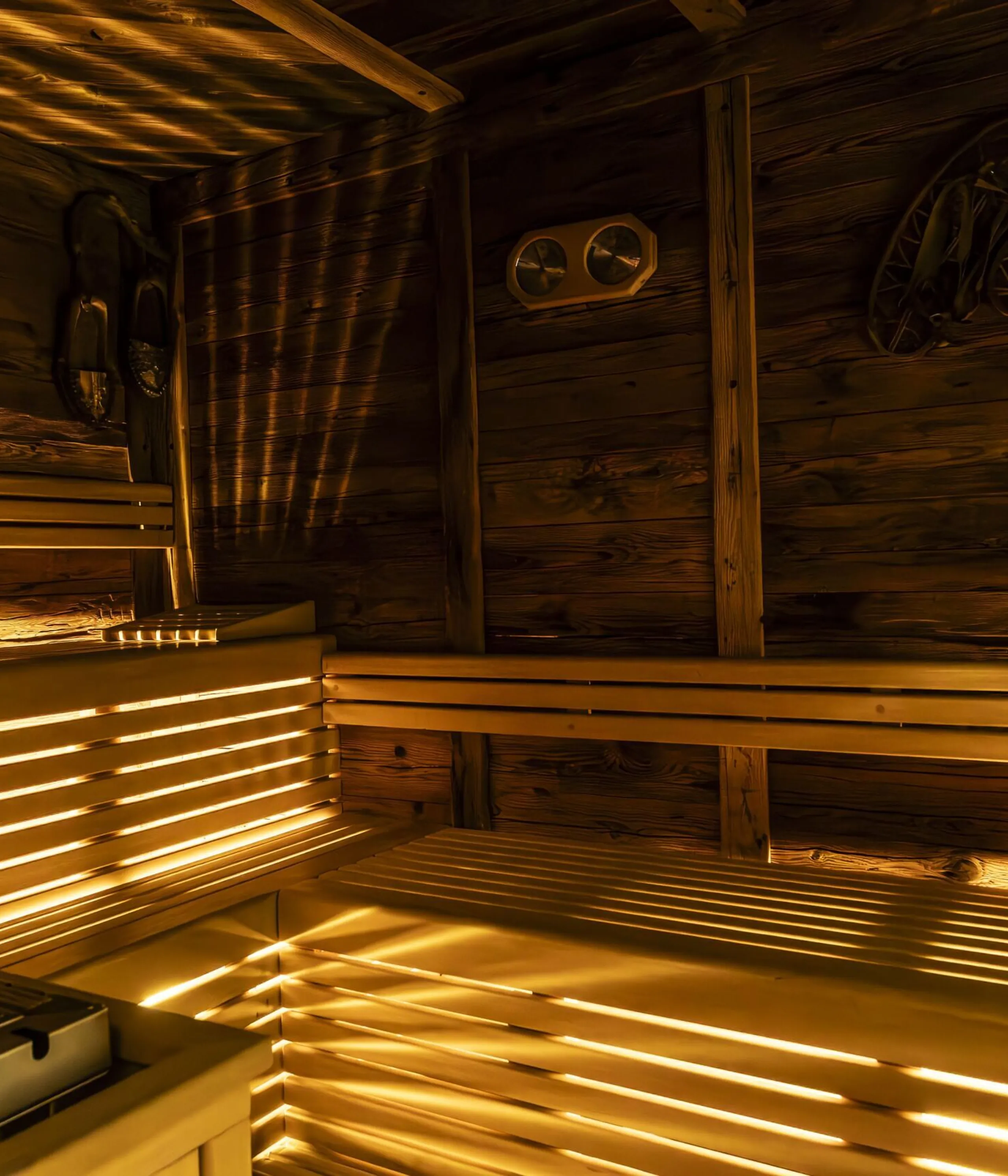 Cozy wooden sauna interior with benches, warm lighting, and rustic Nordic accents.